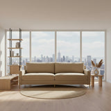 Beige sofa on a concrete floor with a white wall background